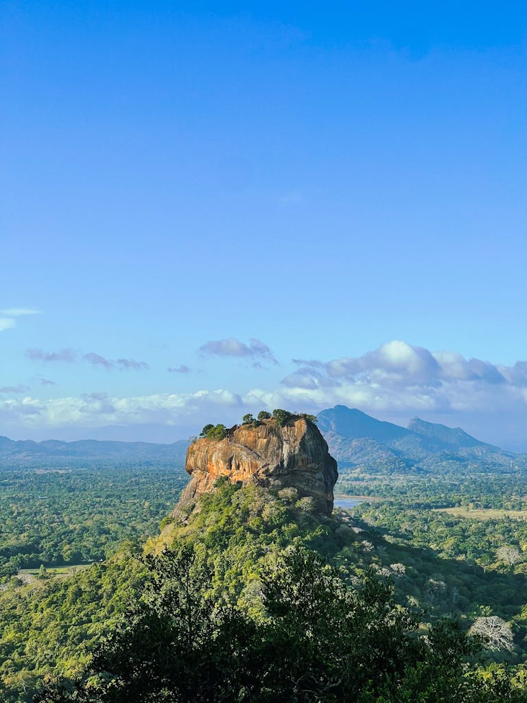 Breathtaking view of Sigiriya, the iconic rock fortress in Sri Lanka, set amidst lush green forests.
