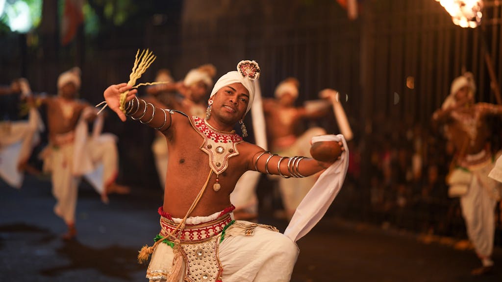 Dynamic night-time tribal dance showcasing traditional costumes and vibrant energy.