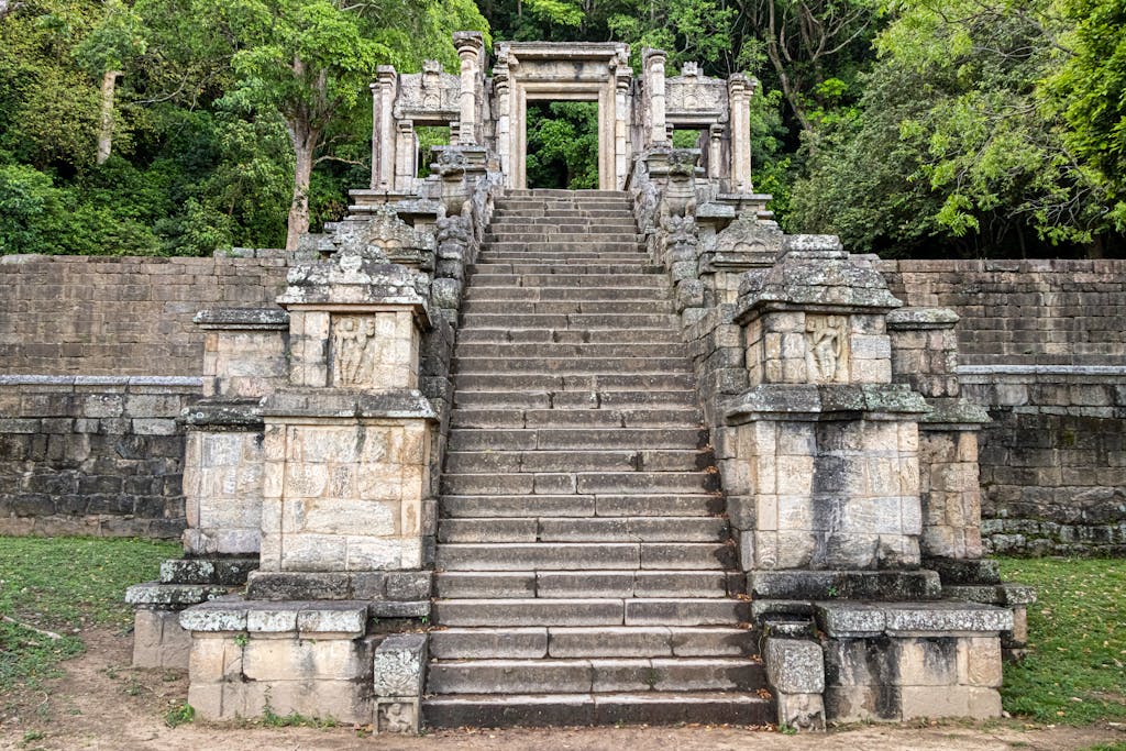 Explore the historic Yapahuwa Rock Fortress surrounded by lush greenery in Sri Lanka.